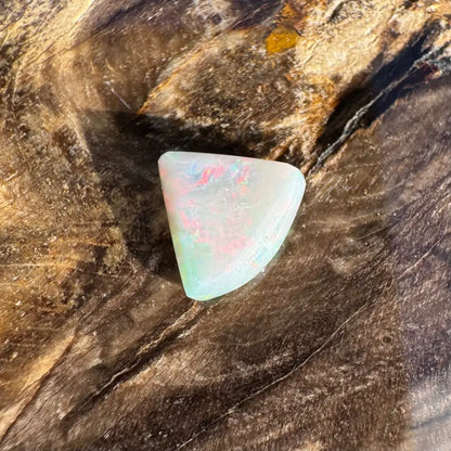 Iridescent triangular opal from Lightning Ridge in the 1.0 carat hand-cut solid opal jewelry