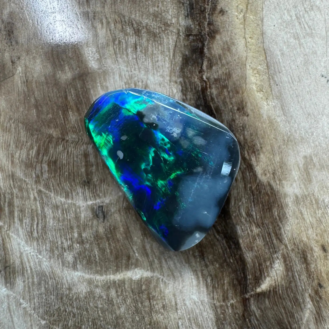 Iridescent black opal gemstone in a 1.2ct Hand-Cut Solid Lightning Ridge Black Opal jewelry piece