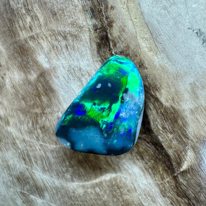 Iridescent opal gemstone from Lightning Ridge in the 1.2 carat hand-cut solid black opal product