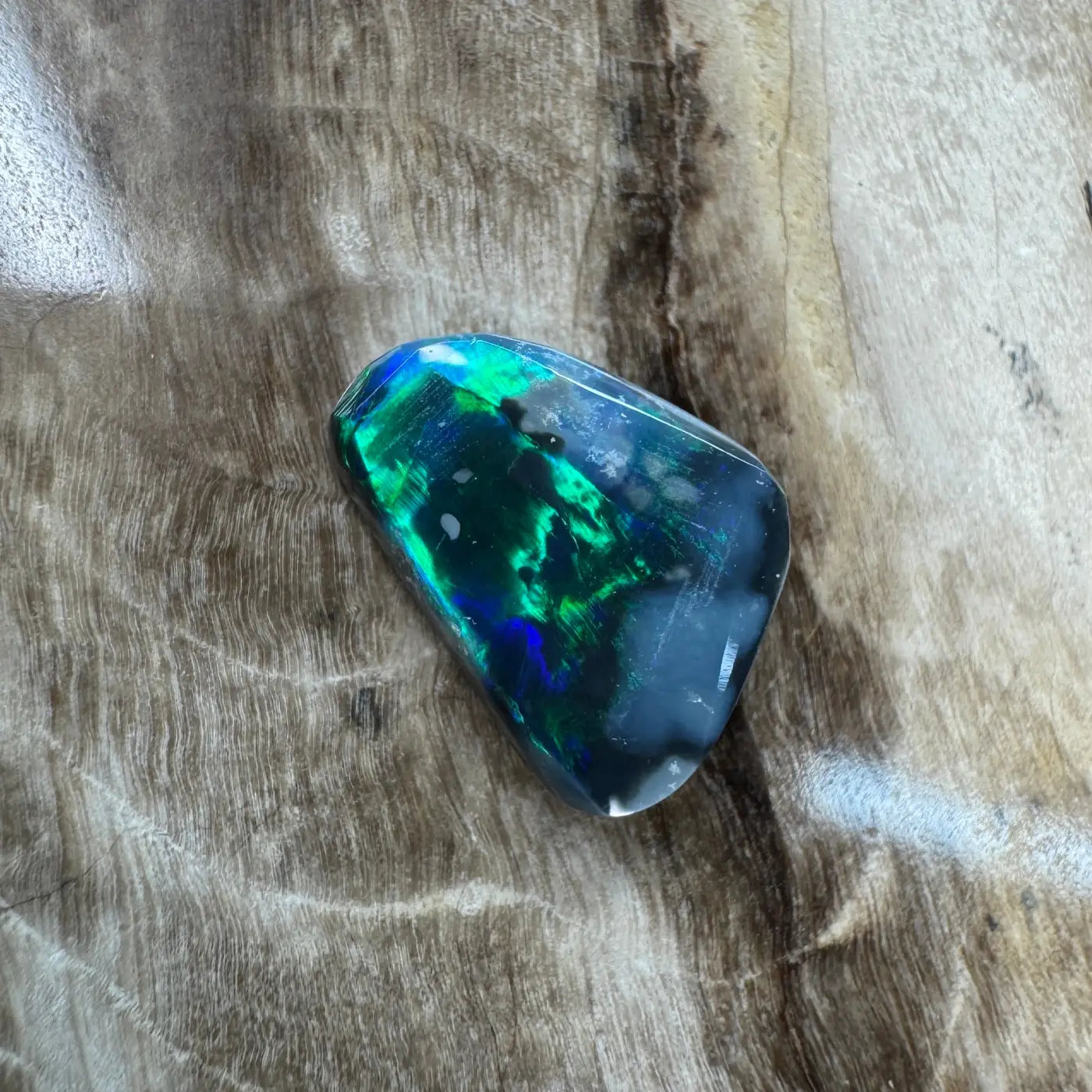 Iridescent black opal gemstone from Lightning Ridge, 1.2ct hand-cut solid specimen