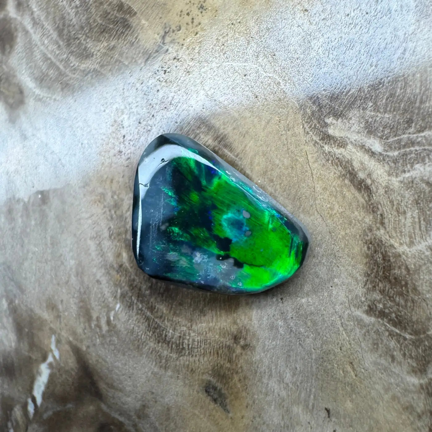 Iridescent green and blue gemstone from 1.2ct Hand-Cut Solid Lightning Ridge Black Opal