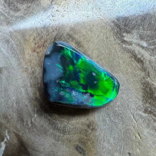 Iridescent green and blue opal from Lightning Ridge in a 1.2ct hand-cut solid black opal