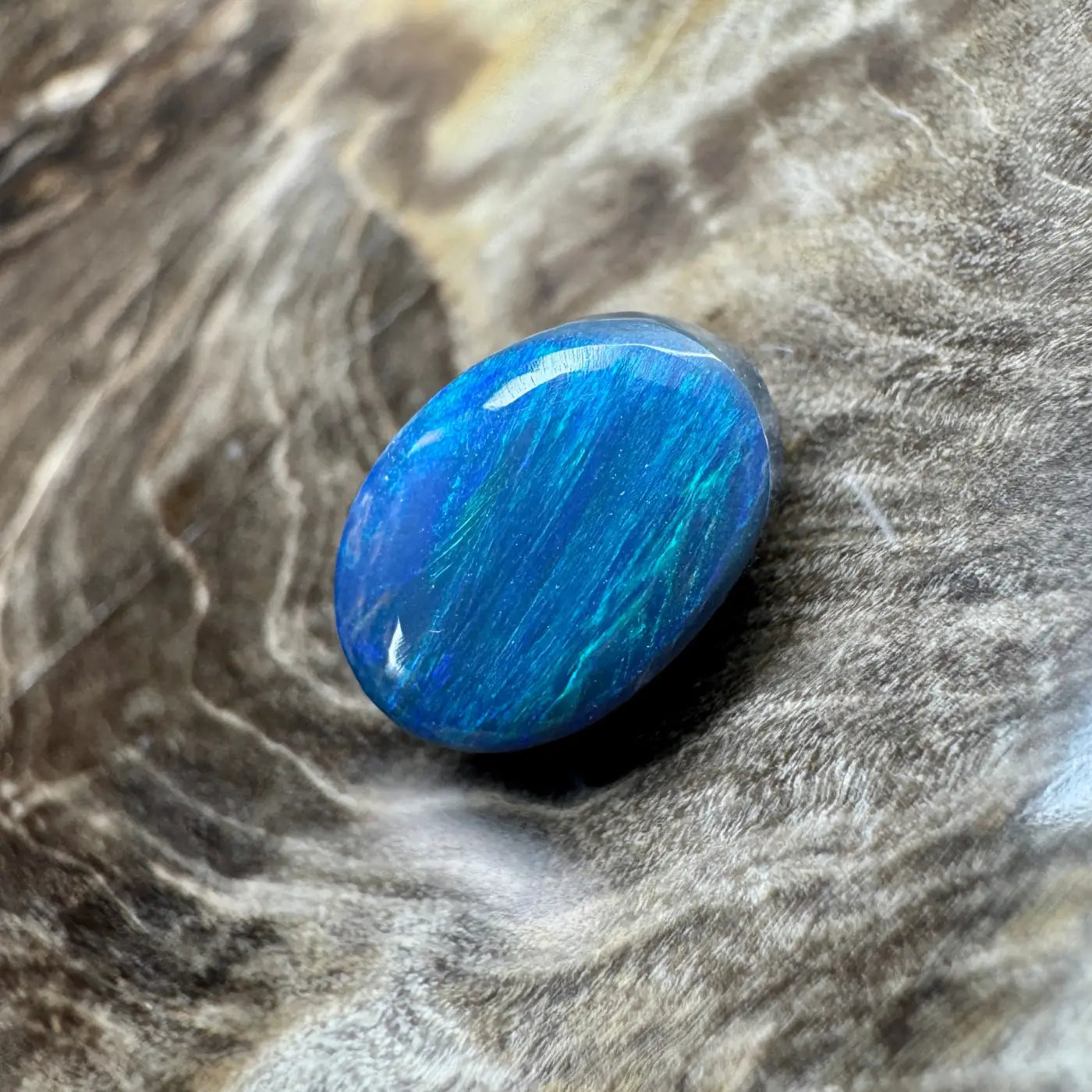 Iridescent blue opal cabochon from the 1.4ct Hand-Cut Solid Lightning Ridge Semi Black Opal jewelry piece