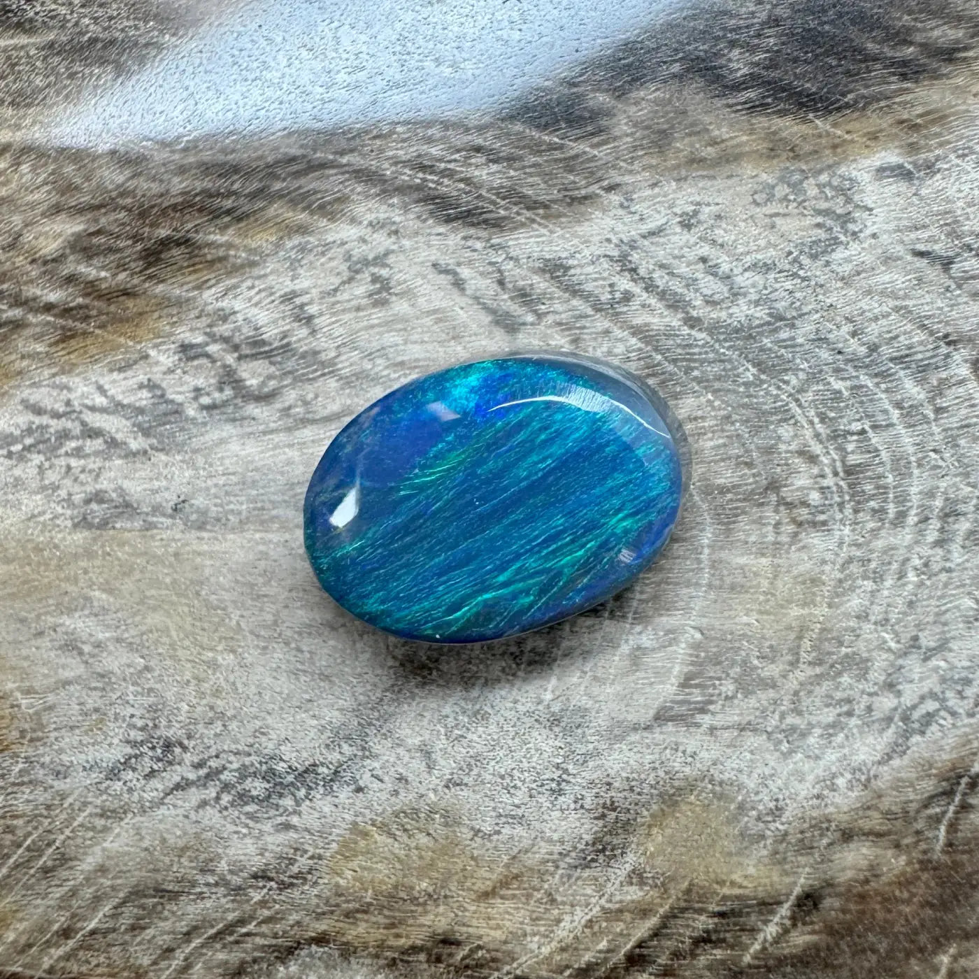 Iridescent blue opal cabochon in the 1.4ct Hand-Cut Solid Lightning Ridge Semi Black Opal