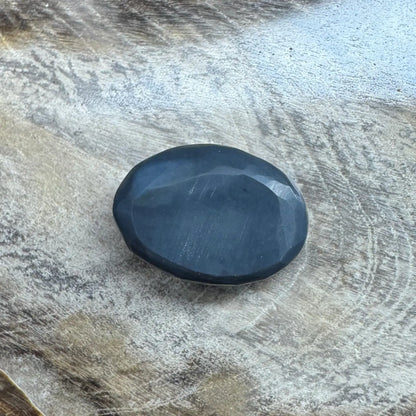 Oval faceted dark gemstone in 1.4ct Hand-Cut Solid Lightning Ridge Semi Black Opal