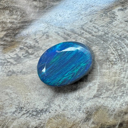 Oval-shaped blue and green opal displayed in 1.4ct Hand-Cut Solid Lightning Ridge Semi Black Opal