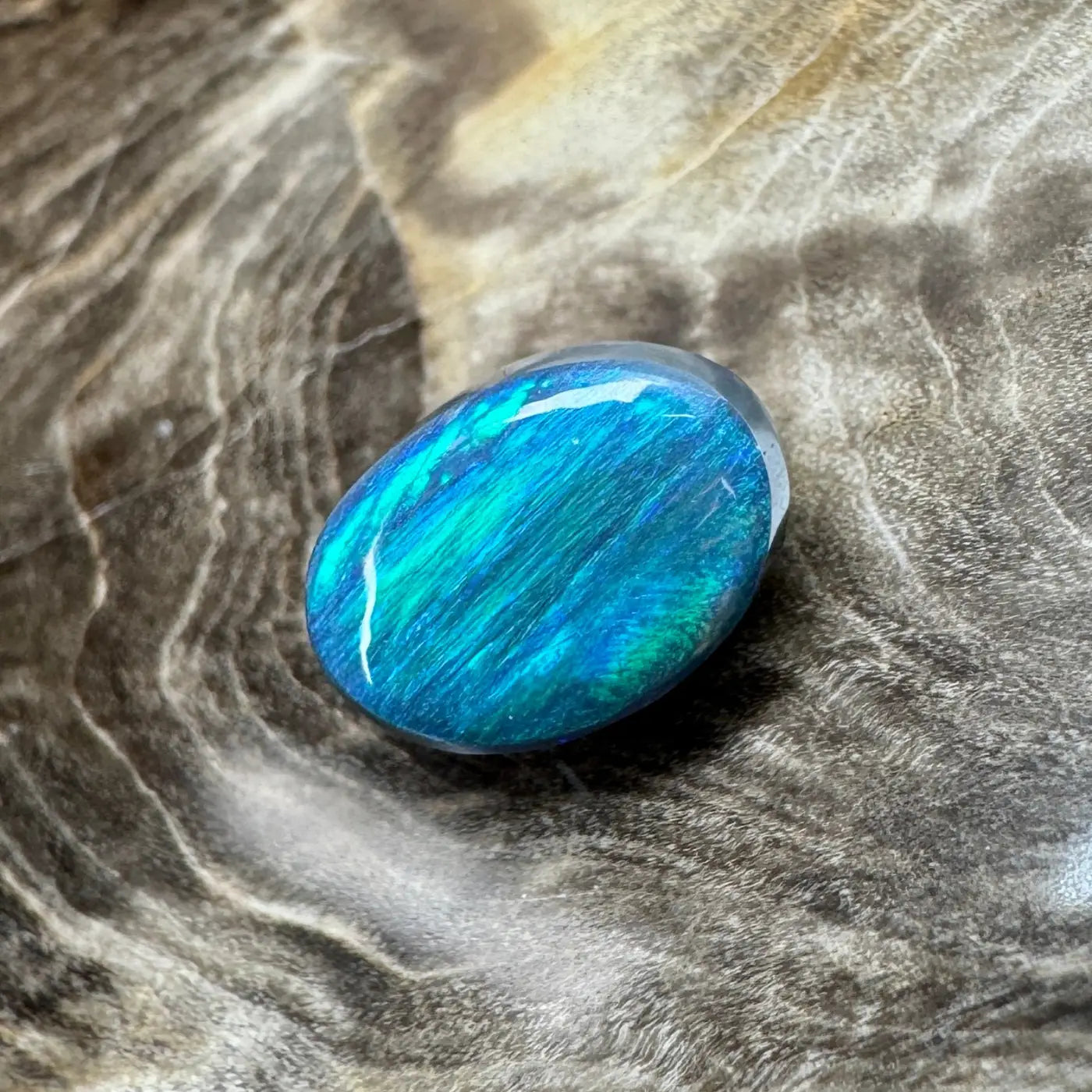 Polished blue-green opal from Lightning Ridge in the 1.4ct Hand-Cut Solid Semi Black Opal product
