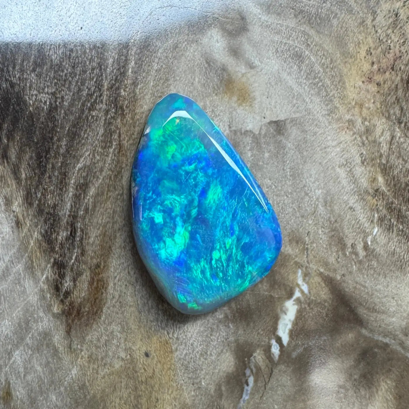 Iridescent blue-green opal cabochon in a 1.8ct Hand-Cut Solid Lightning Ridge Semi Black Opal jewelry piece