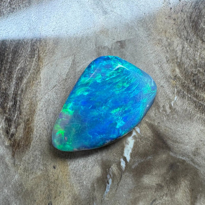 Iridescent blue-green opal from Lightning Ridge in a 1.8 carat hand-cut solid semi-black opal