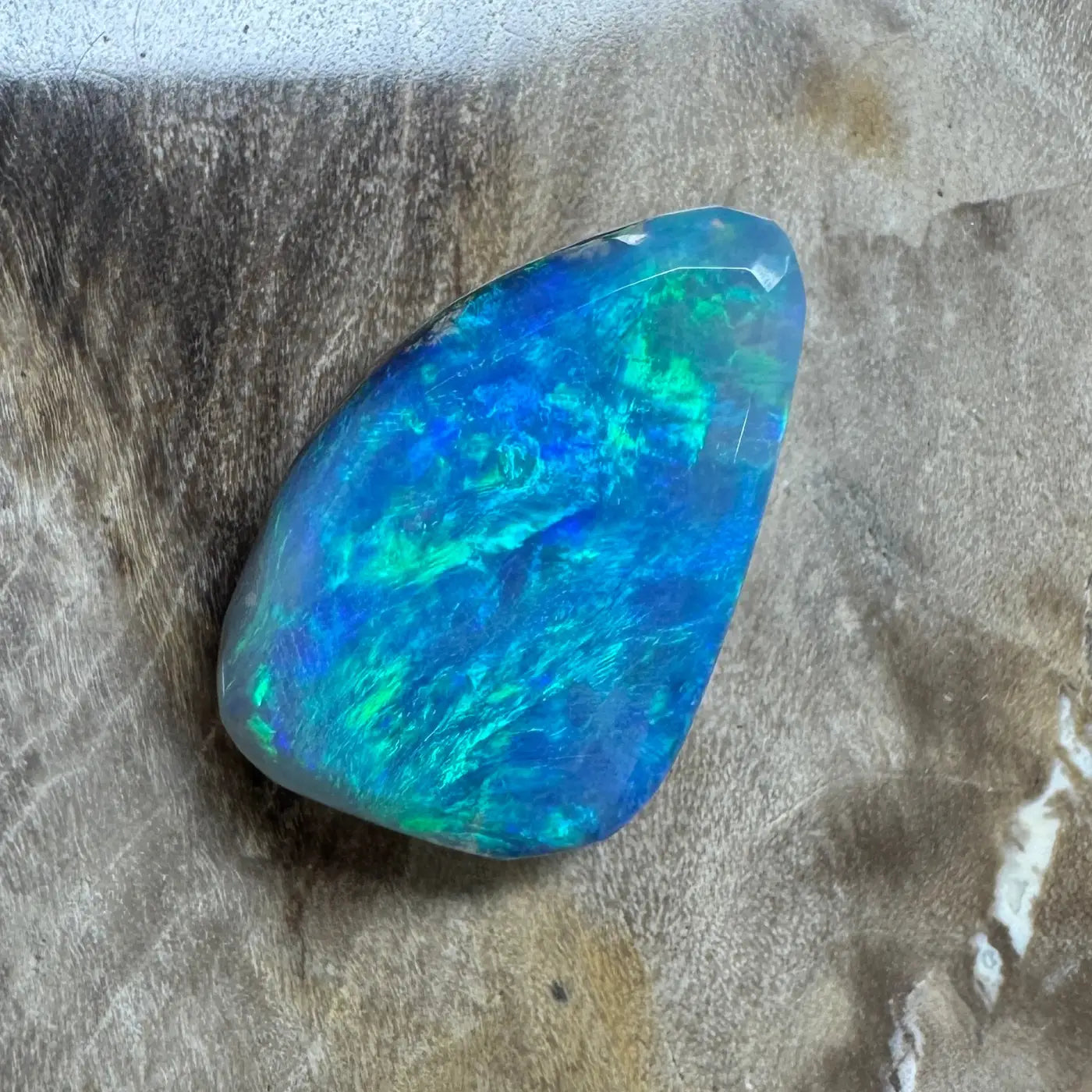 Iridescent blue-green opal gemstone in the 1.8ct Hand-Cut Solid Lightning Ridge Semi Black Opal