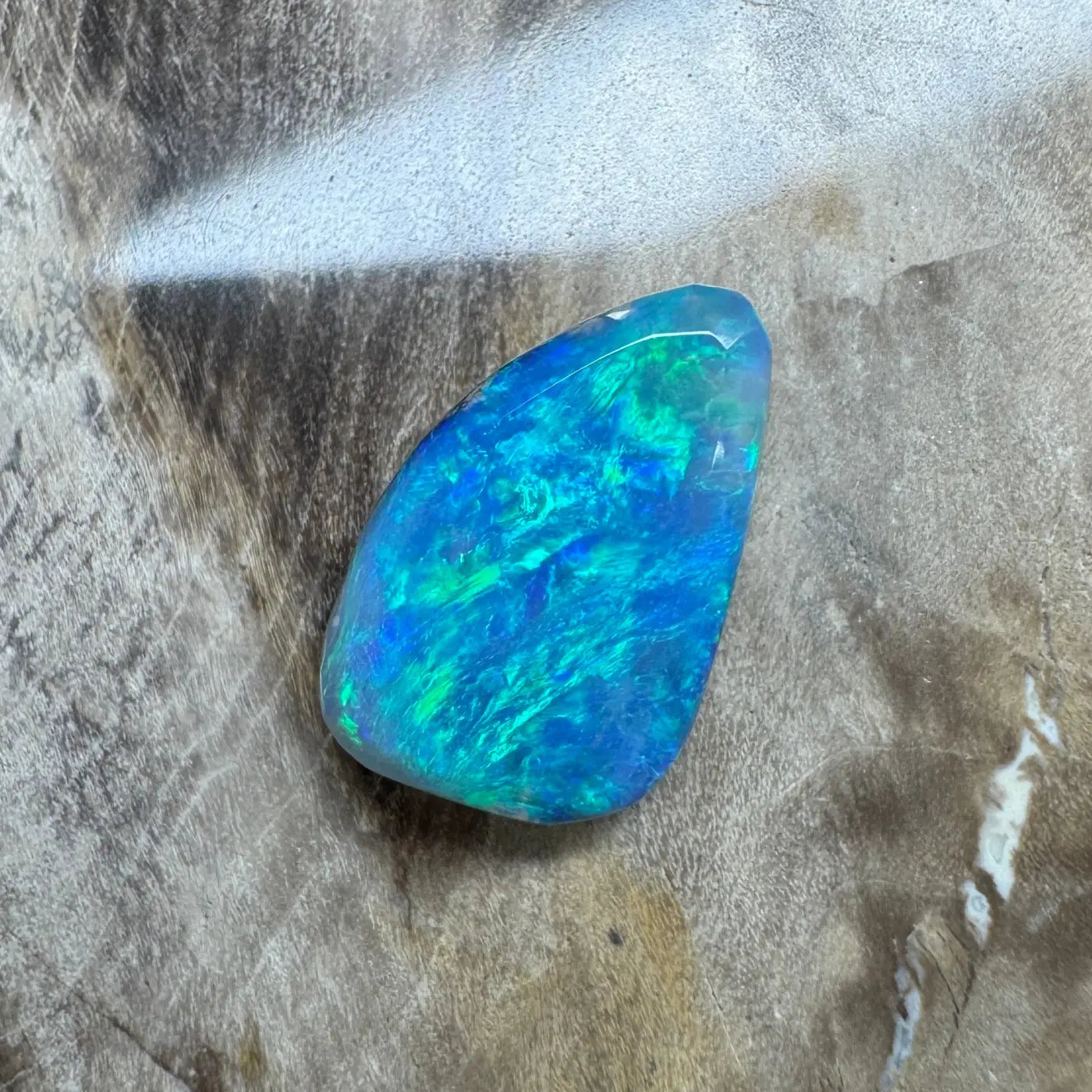 Iridescent blue-green opal gemstone displayed in 1.8ct Hand-Cut Solid Lightning Ridge Semi Black Opal