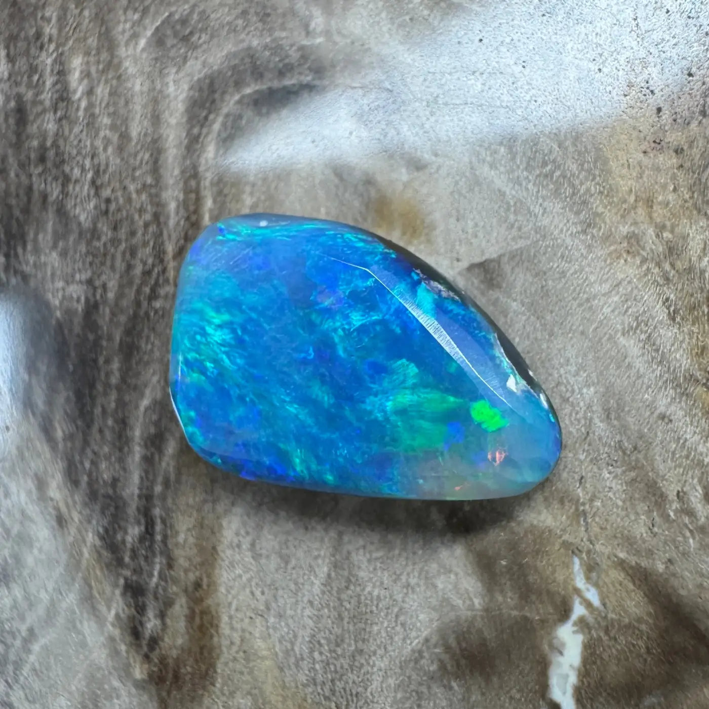 Iridescent blue-green Lightning Ridge semi-black opal gemstone in a 1.8ct hand-cut setting