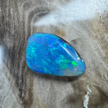 Iridescent blue-green Lightning Ridge semi-black opal gemstone in a 1.8ct hand-cut setting