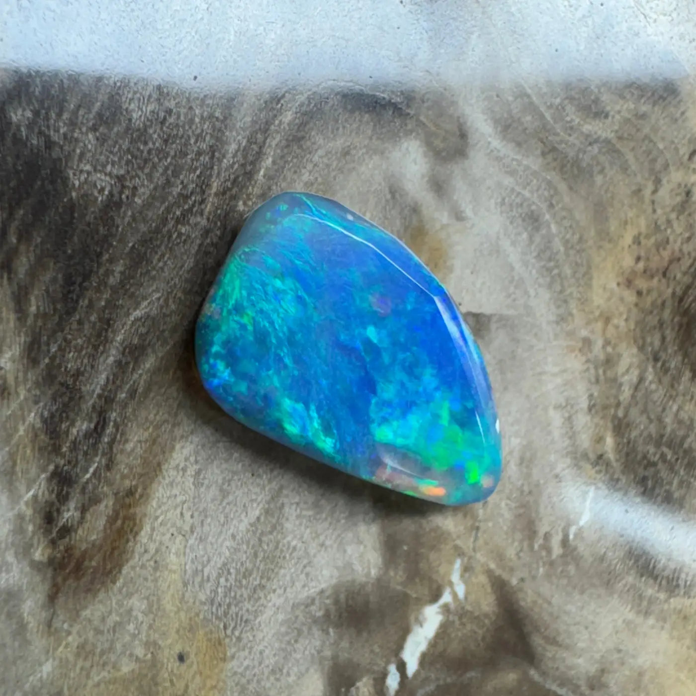 Iridescent blue opal gemstone from Lightning Ridge in a 1.8 carat hand-cut semi-black opal