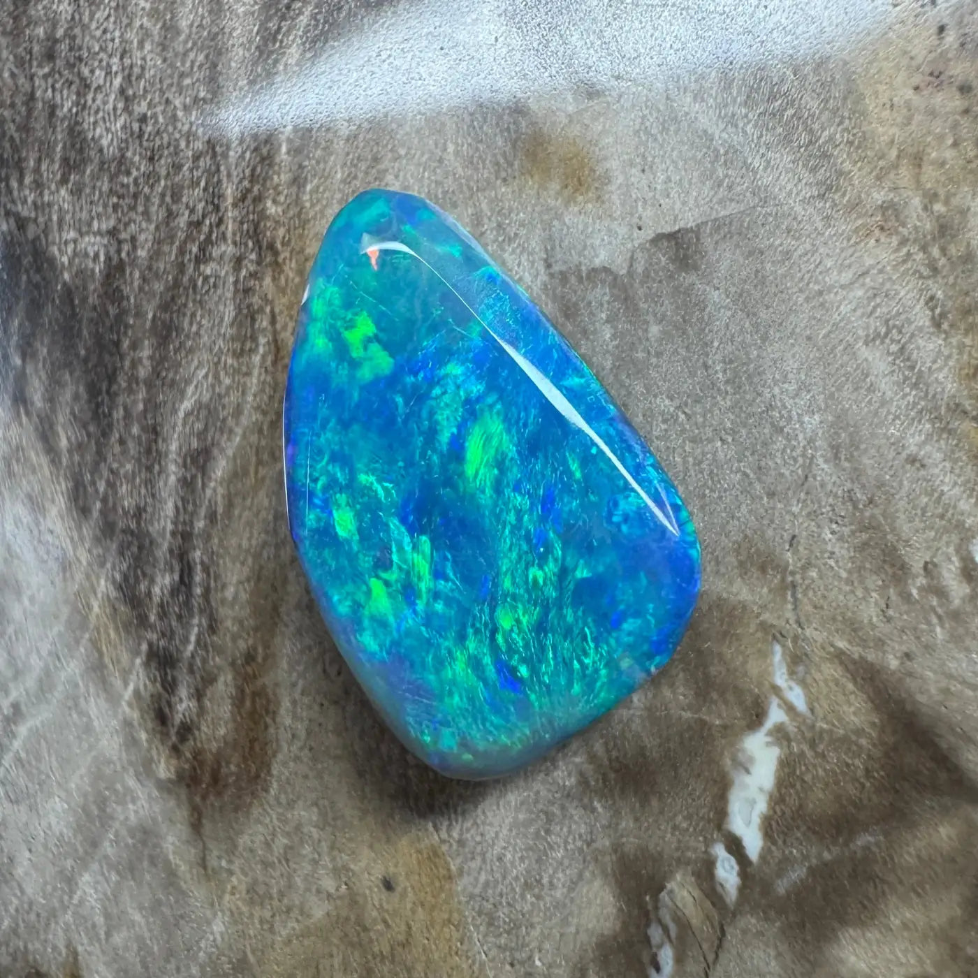 Iridescent blue and green opal gemstone in the 1.8ct Hand-Cut Solid Lightning Ridge Semi Black Opal