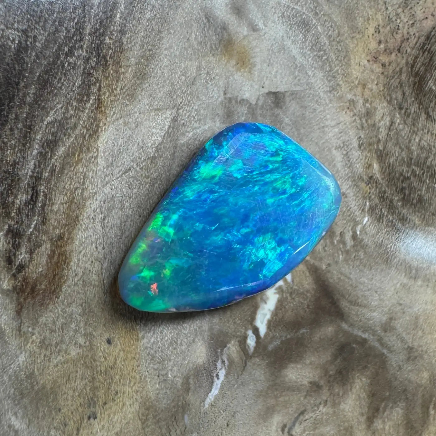 Irregular iridescent blue opal gemstone in the 1.8ct Hand-Cut Solid Lightning Ridge Semi Black Opal jewelry