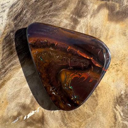 Polished dark opal gemstone.