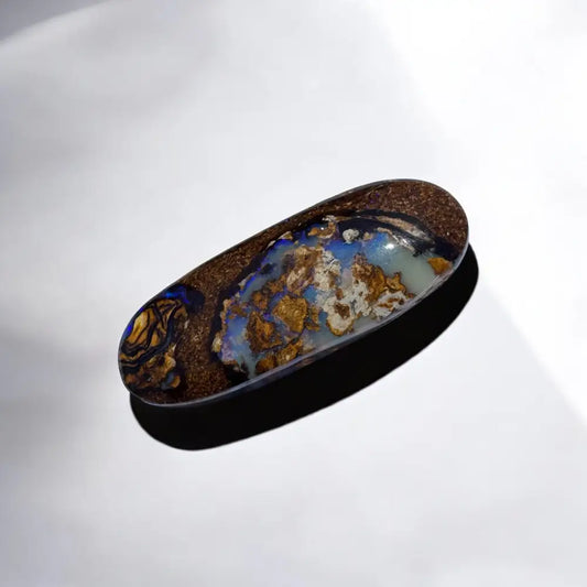 Oval-shaped Queensland Boulder Opal with vibrant blue and gold play-of-color