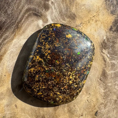 Polished boulder opal with vibrant color play.