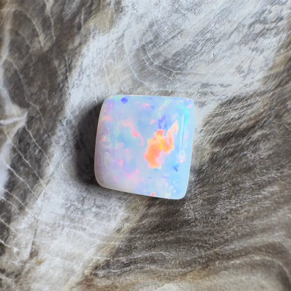 Iridescent, square opal cabochon.