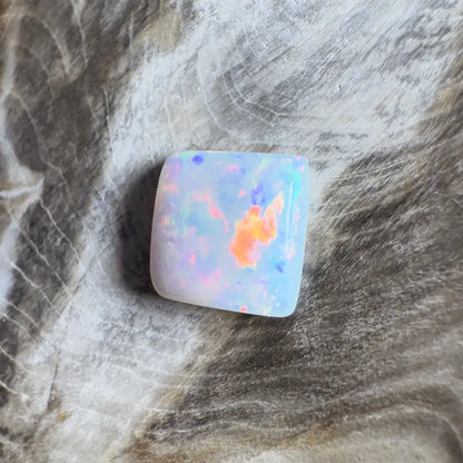 Iridescent, square opal cabochon.