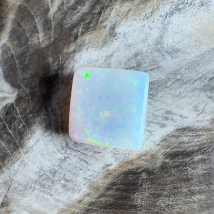 Square opal cabochon with iridescent play-of-color.