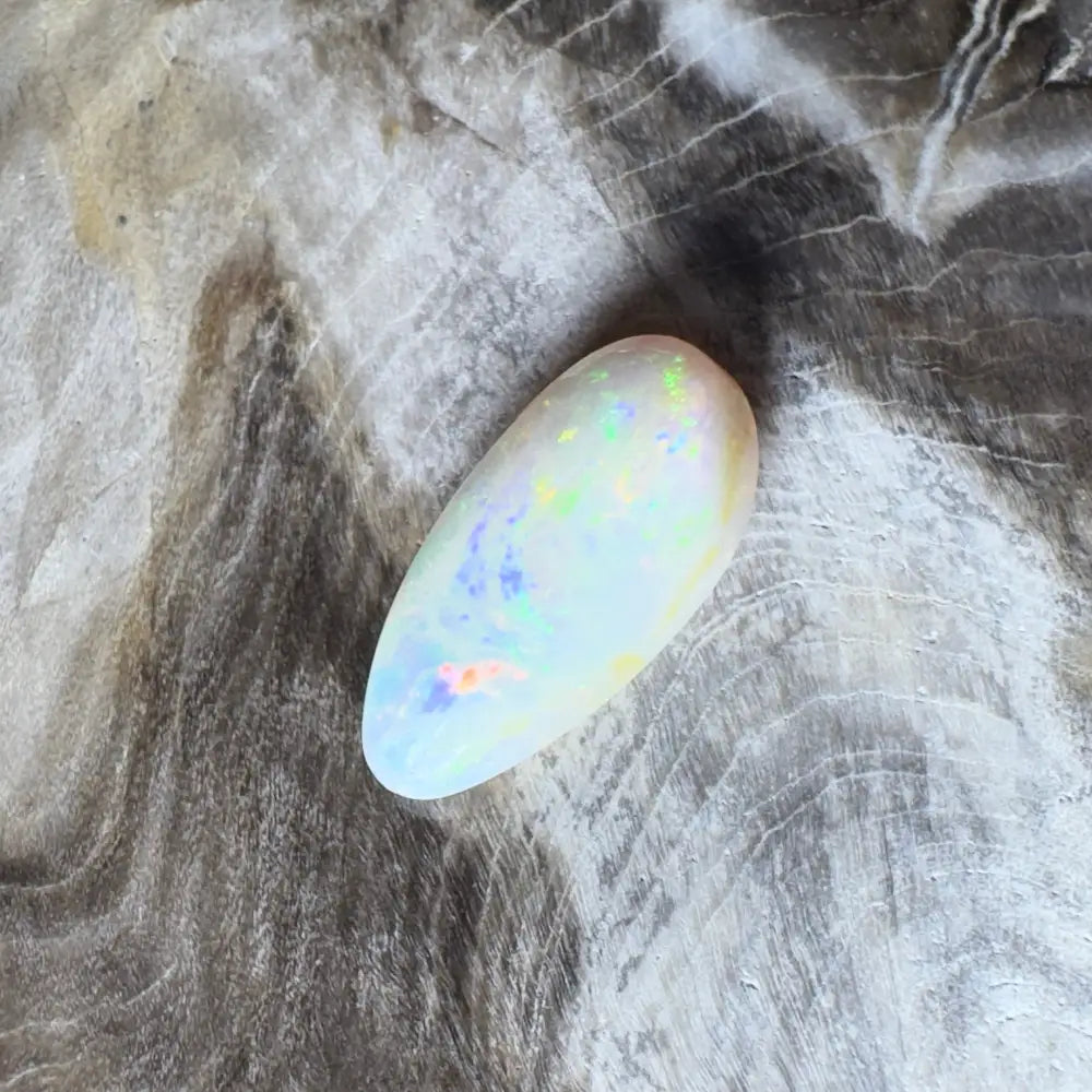 Iridescent white opal cabochon.