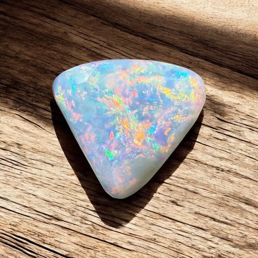 Iridescent triangular opal from Lightning Ridge showcasing vibrant color play