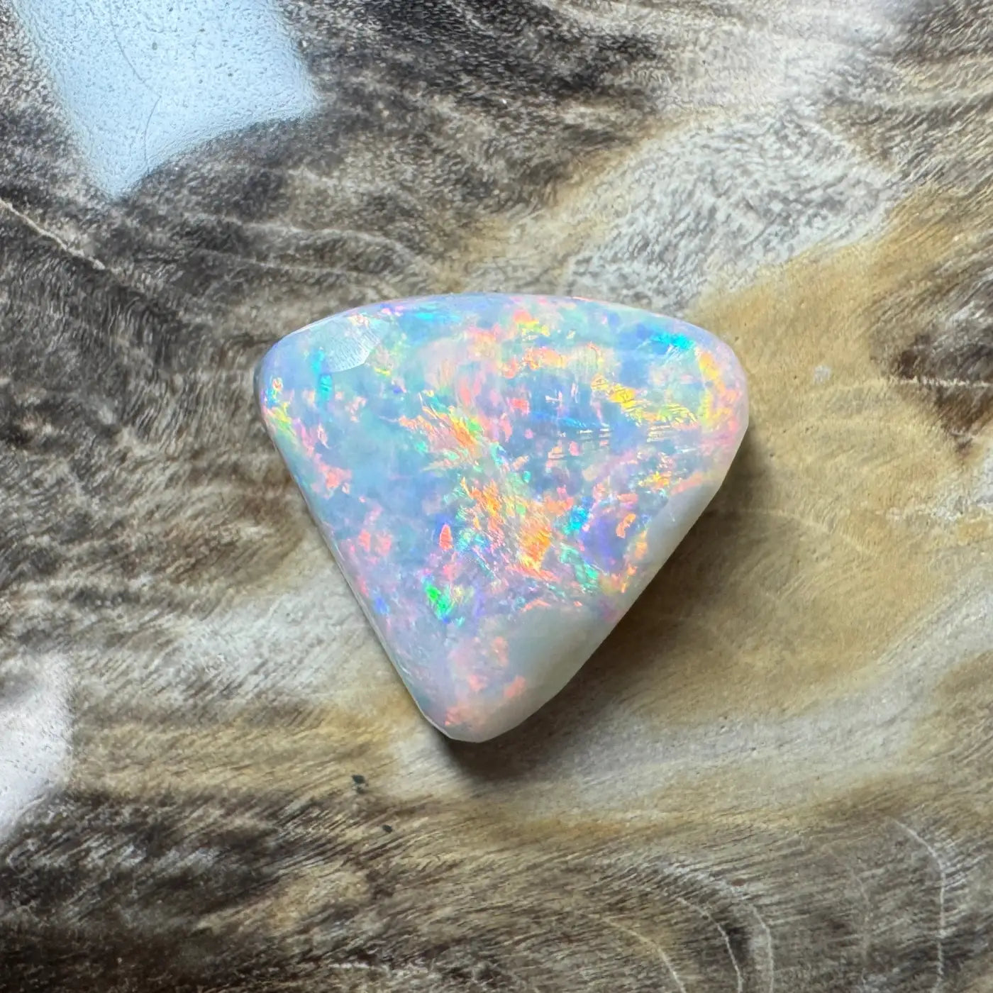 Iridescent triangular Lightning Ridge semi black opal in a 2.9 carat hand-cut jewelry piece
