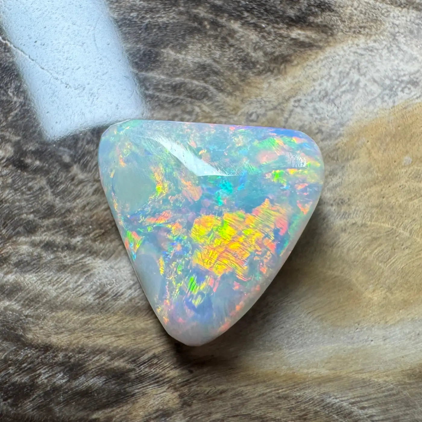 Iridescent triangular Lightning Ridge semi-black opal gemstone in the 2.9ct hand-cut solid collection