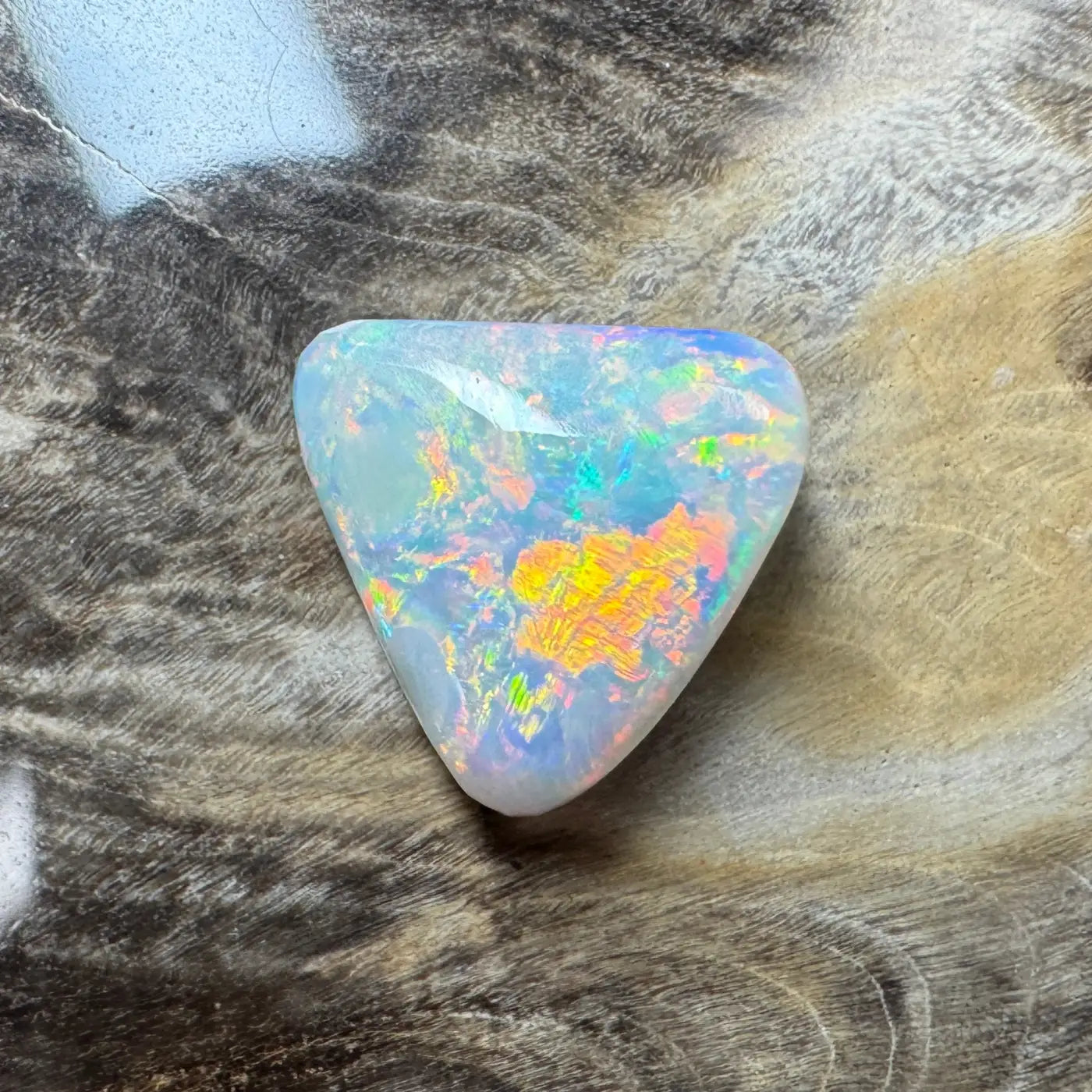 Iridescent triangular Opal from Lightning Ridge in a 2.9ct hand-cut semi black opal jewelry piece
