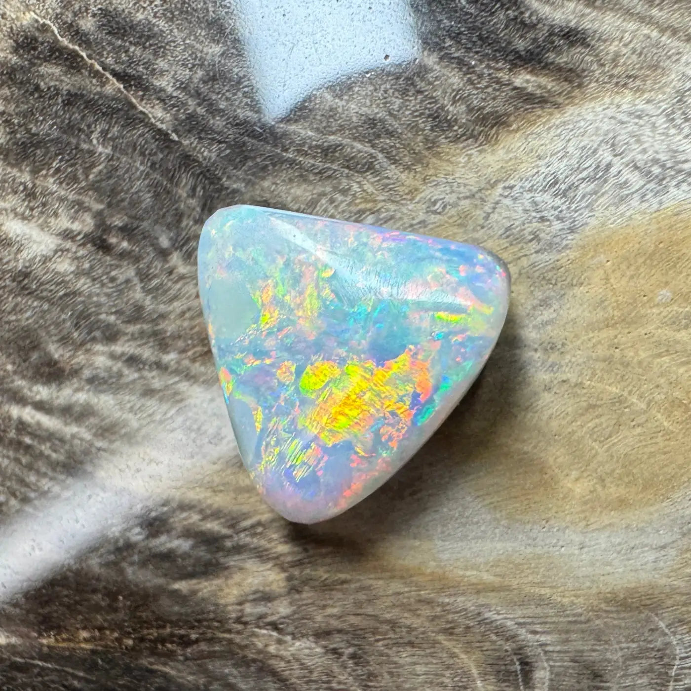 Iridescent triangular Lightning Ridge semi-black opal in the 2.9ct hand-cut solid collection