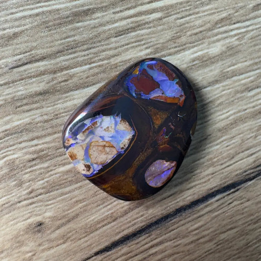 Polished 21.9 carat Queensland Boulder Opal with vibrant color play and natural pipe formations