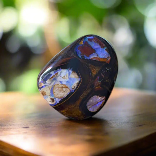Polished black opal with iridescent inclusions in 21.9ct hand-cut Queensland Boulder Opal with Pipes