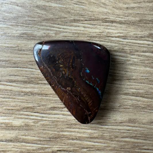 Polished 29.8ct Queensland Boulder Opal with dark tone and vibrant blue-green flashes