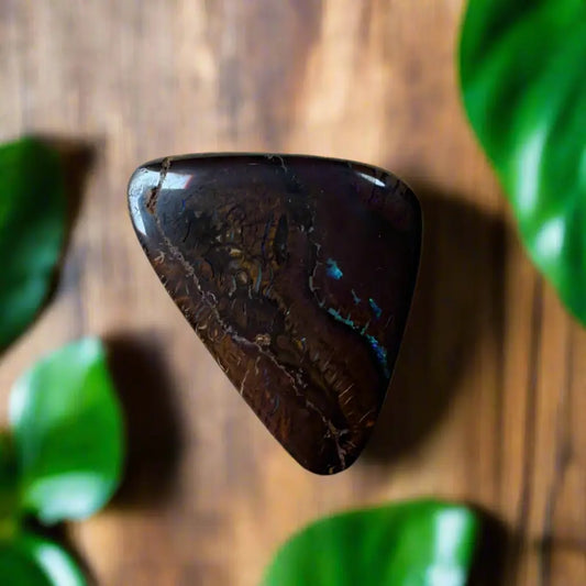 Polished dark-toned Queensland Boulder Opal with iridescent flashes displaying 29.8ct weight
