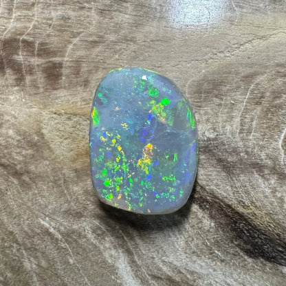Iridescent opal gemstone from Lightning Ridge in the 3.2carat hand-cut solid semi-black opal product