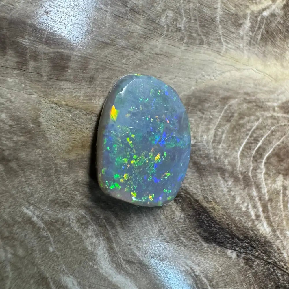 Iridescent opal gemstone from Lightning Ridge in a 3.2 carat hand-cut semi black opal