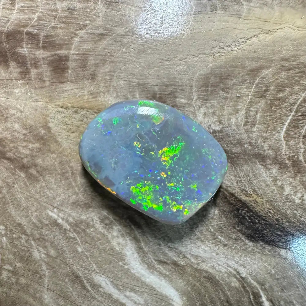Iridescent opal gemstone in a 3.2 carat hand-cut solid Lightning Ridge semi Black Opal