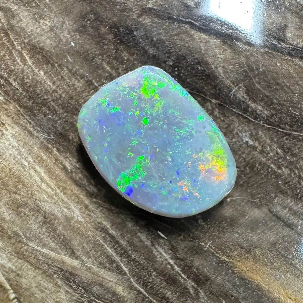 Iridescent opal gemstone in a 3.2 carat hand-cut Lightning Ridge semi black opal jewelry piece