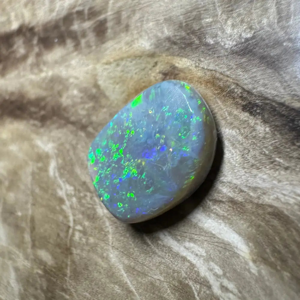 Iridescent opal gemstone from Lightning Ridge in a 3.2 carat hand-cut solid semi-black opal product