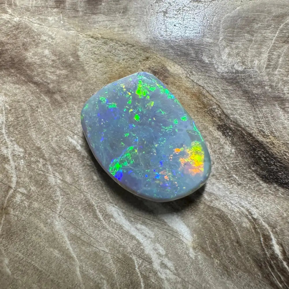 Iridescent Opal gemstone from Lightning Ridge in a 3.2 carat hand-cut solid setting