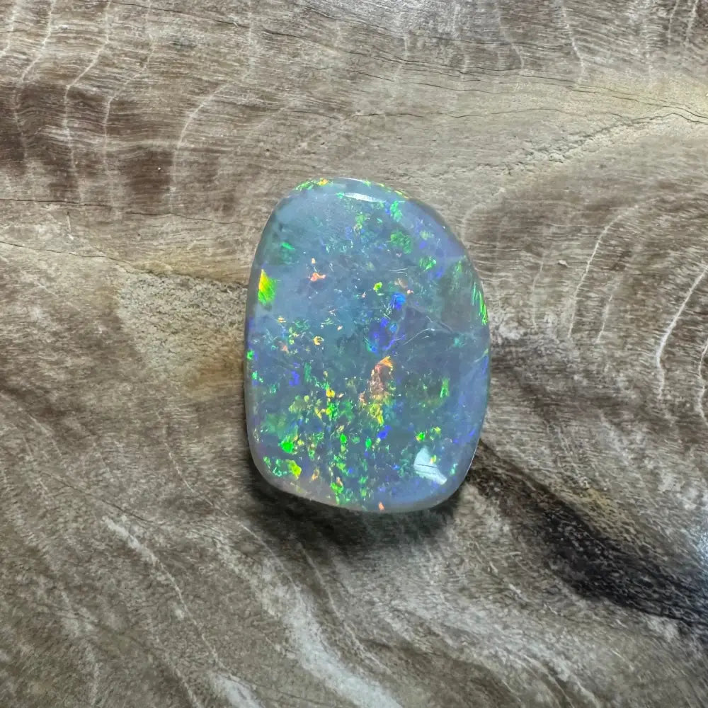 Iridescent opal gemstone from Lightning Ridge in a 3.2 carat hand-cut semi black opal display