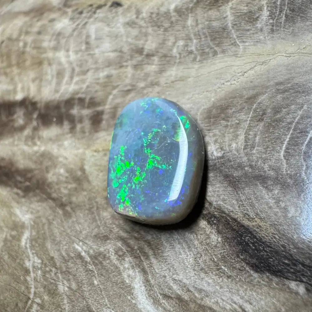 Polished Lightning Ridge semi black opal with green and blue iridescence, 3.2 carats