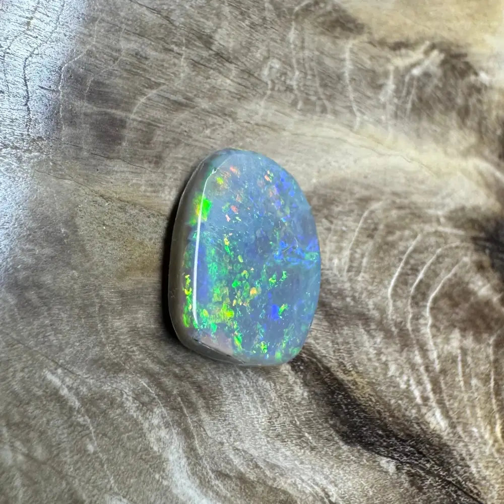 Iridescent opal gemstone from Lightning Ridge in a 3.2 carat hand-cut semi black opal product