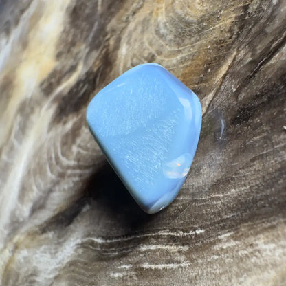 Polished, light blue gemstone.