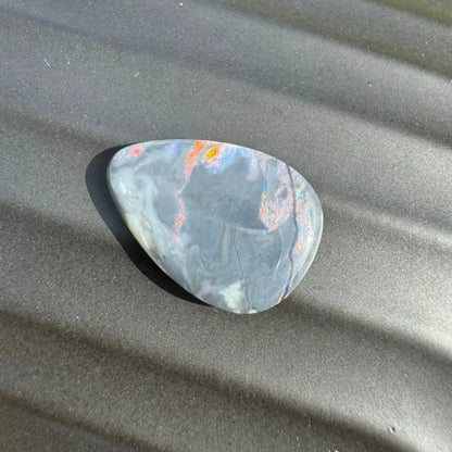 Polished multicolored Lightning Ridge semi-black opal cabochon for jewelry design