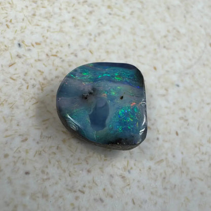 Iridescent blue-green Queensland Boulder Opal cabochon in a 5.9ct hand-cut display