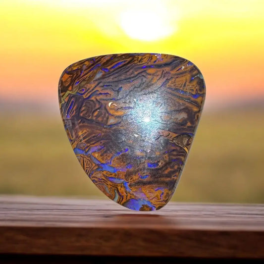 Iridescent shield-shaped 7.8ct Hand-cut Queensland Boulder Opal gemstone