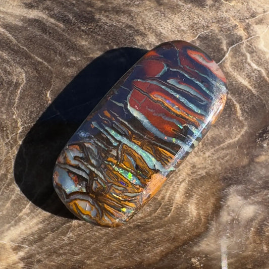 Polished Boulder Opal with vibrant color play in 8.3 Carat Hand-Cut Solid Boulder Opal